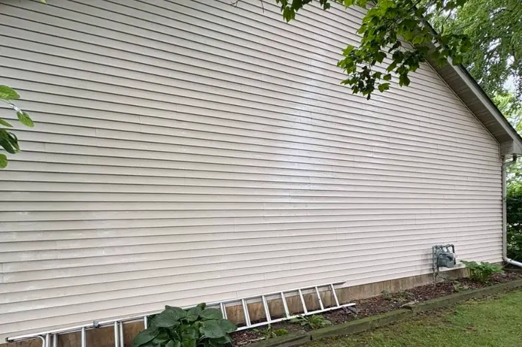 Clean cream vinyl siding on the side of a house